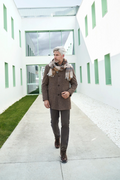 Man walking in a modern architectural setting with green accents